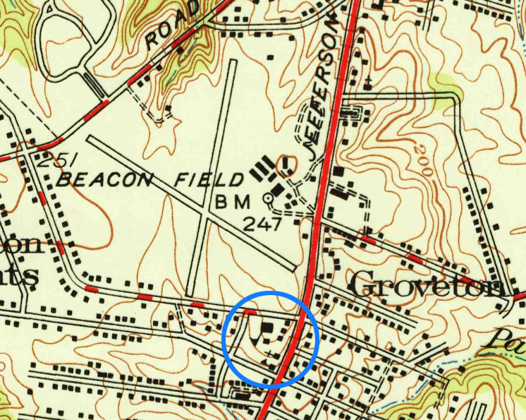 Detail of a color map of Fairfax County showing Groveton Elementary School and the Beacon Field Airport. The map is light beige in color with brown lines indicating elevation. The school and airport are more than 200 feet above sea level. Black squares indicate residences and buildings. The airport's two runways are laid out north to south and east to west, crossing in the center, they form the letter X. The schoolhouse symbol is a square with a triangular flag atop a pole. Churches are a square with a cross on top.  